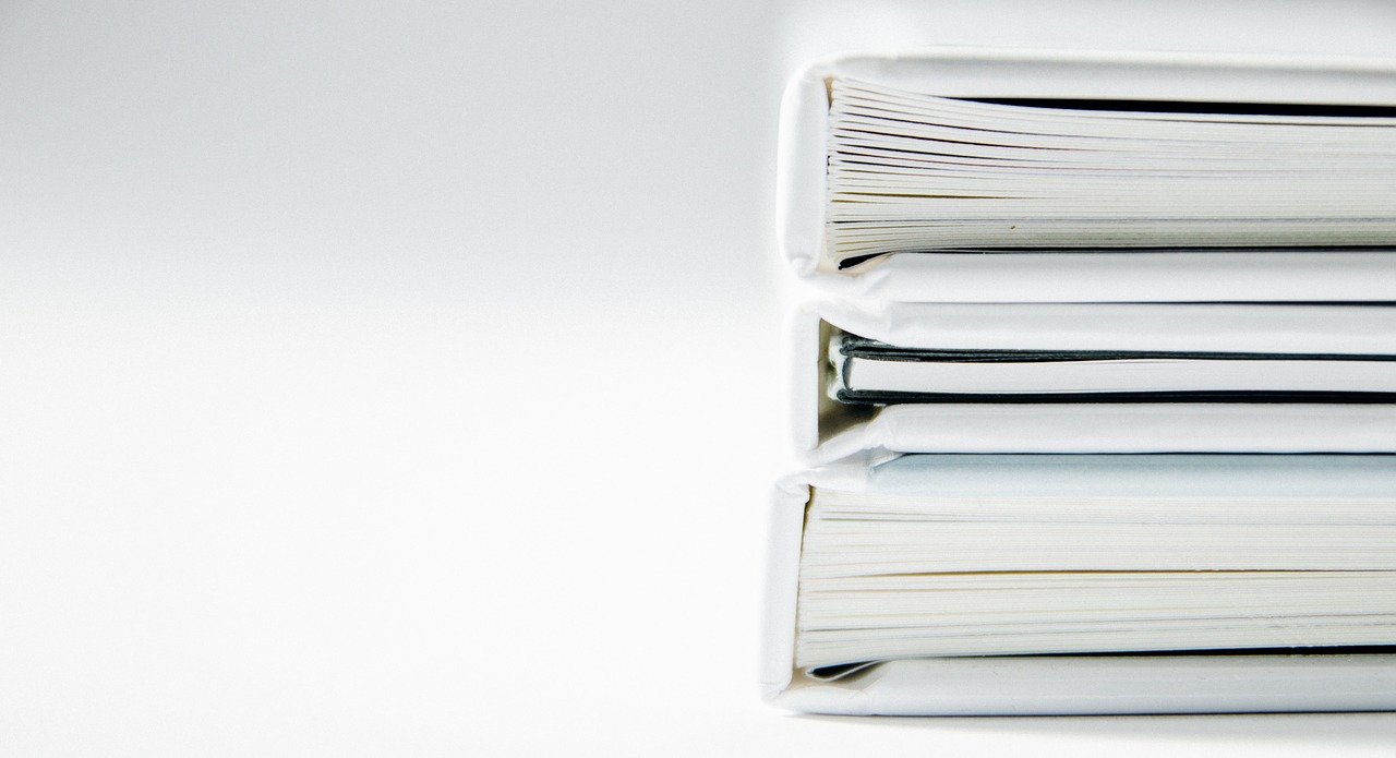 Image of three white book stacked on top of each other