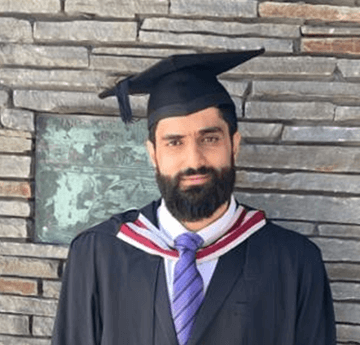 A portrait of a male student in his graduation gown and cap.