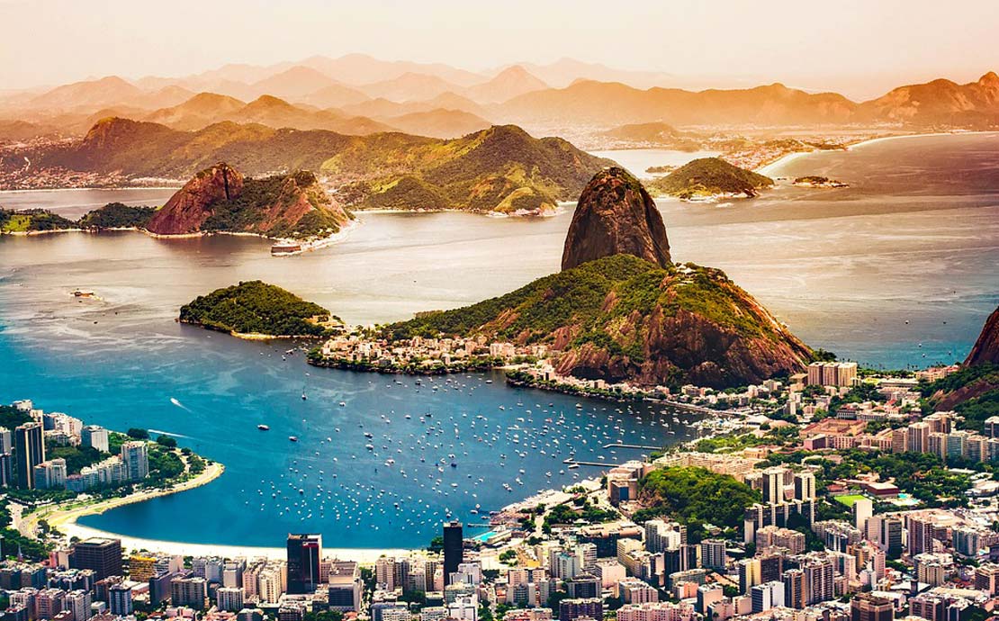 a panoramic view of rio de janeiro in brazil, looking down at the beach and bright blue sea