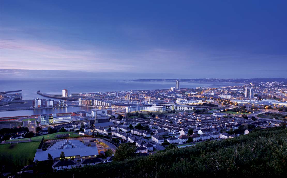 a panoramic view of swansea bay at dusk