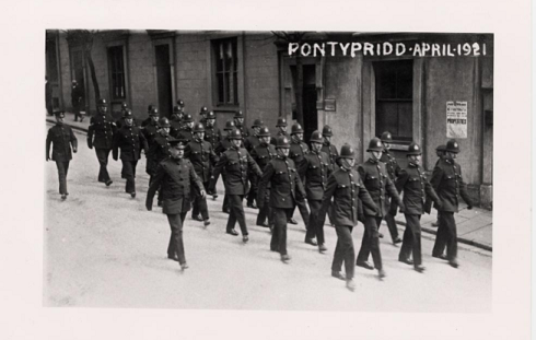 Police regiment marching through Pontypridd