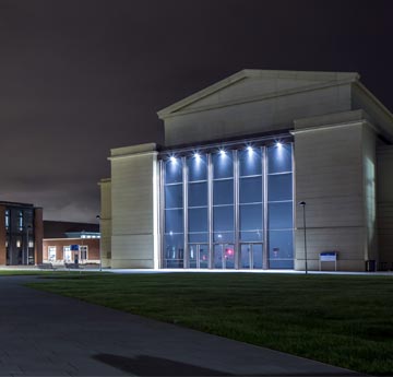 The Great Hall at Bay Campus, lit up at night. 