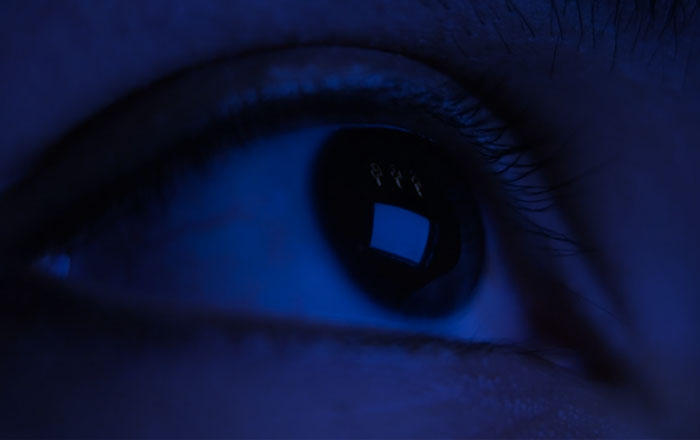 A computer screen reflected on a close-up image of an eye.