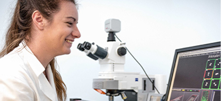 PGR student with microscope