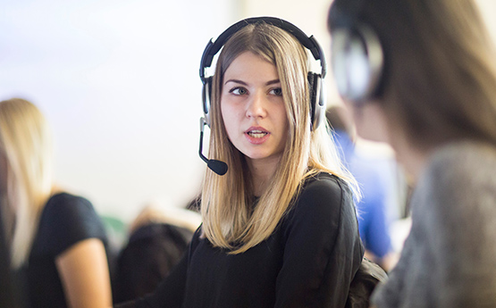 Student wearing headset while doing a translation exercise.