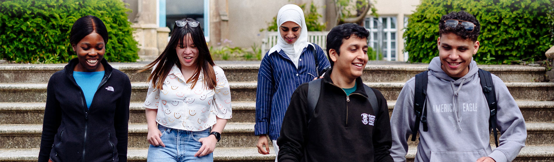 5 students walking down the steps by Singleton Abbey