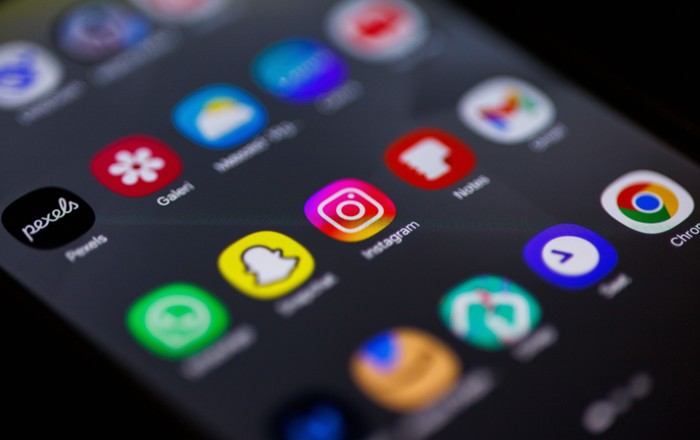 A close up of a mobile phone showing social media app icons
