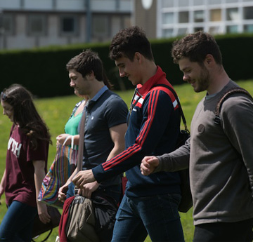 Group of students waling by the Abbey on Singleton Campus