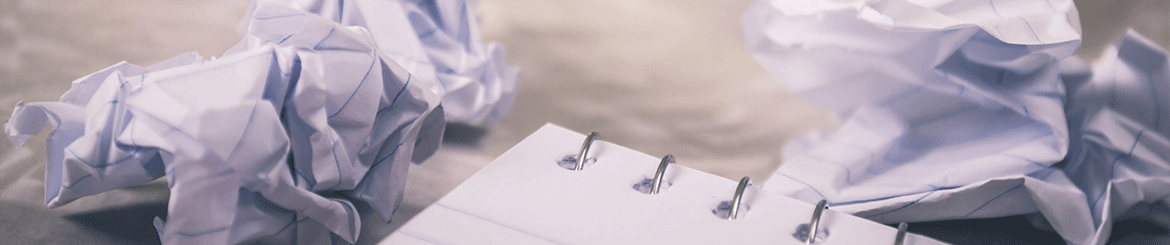 Screwed up pieces of paper.