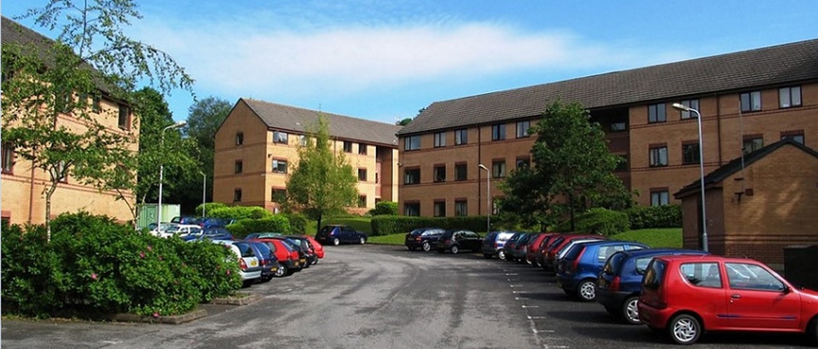 Student Village hill with residence exteriors and cars