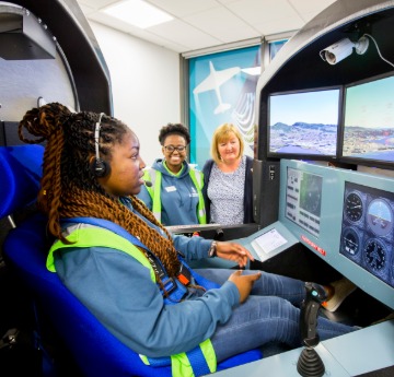 Student ambassador on Open Day in a simulator