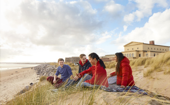 A group of students sat on the beach
