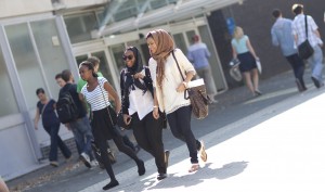 Girls laughing and chatting whilst walking along the mall