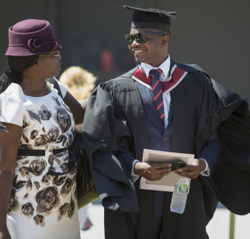 a male student graduating, stood with a woman