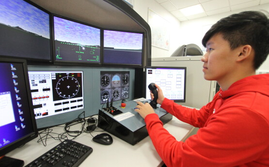 Student using a flight simulator 