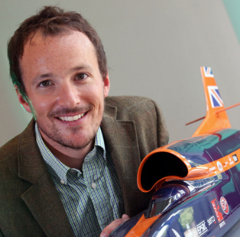 A picture of Dr Evans holding a model of Bloodhound.