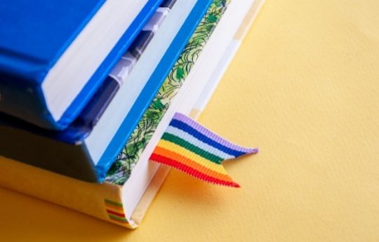 Rainbow bookmark and stack of books 