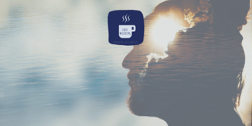 the faint outline of a man's head with the sun rising in the background of the ocean below