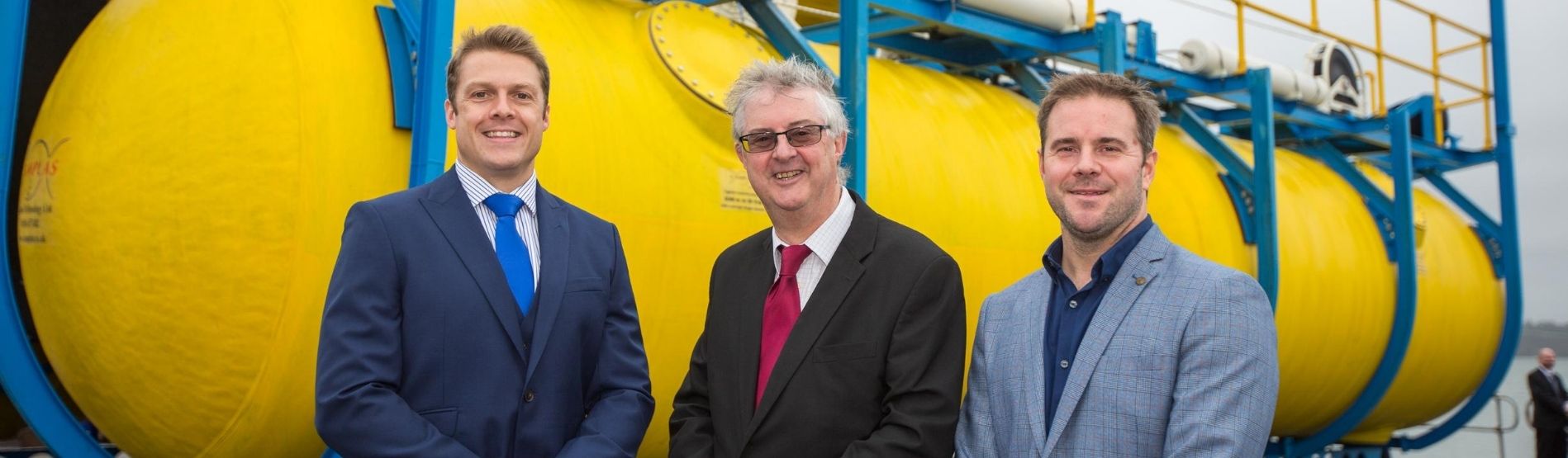 Dr Gareth Stockman, Mark Drakeford (First Minister of Wales) and Dr Graham Foster standing in front of the Wave Sub.