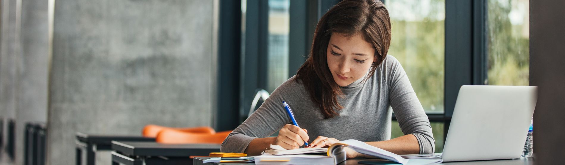 Student writing in a notebook