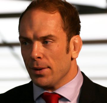 Man wearing a shirt and tie being interviewed 