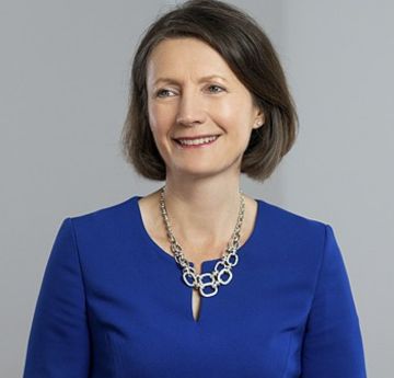 Image of a businesswoman in a blue dress smiling