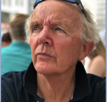 Man sitting on a table outside wearing sunglasses