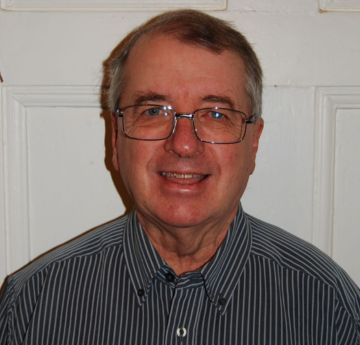 Head & shoulder shot of a man smiling at the camera