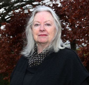 Lady standing outside smiling at the camera