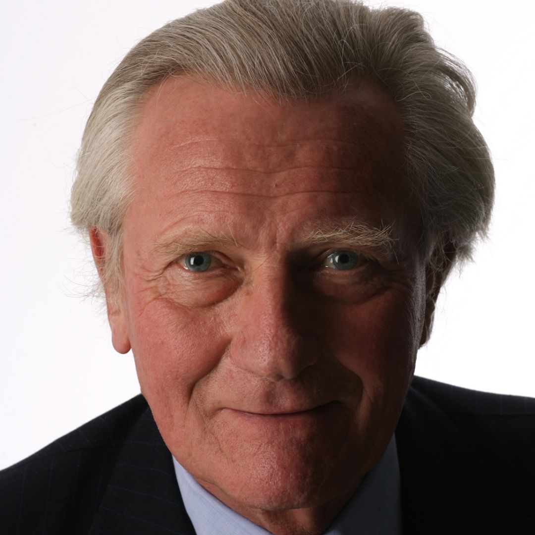 Man wearing a suit smiling at the camera