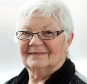 Lady with glasses smiling at the camera