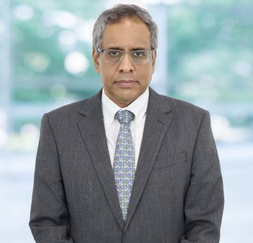 Image of a man in a business suit looking at the camera