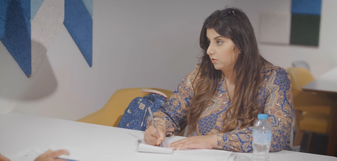 Lady sitting at a desk writing