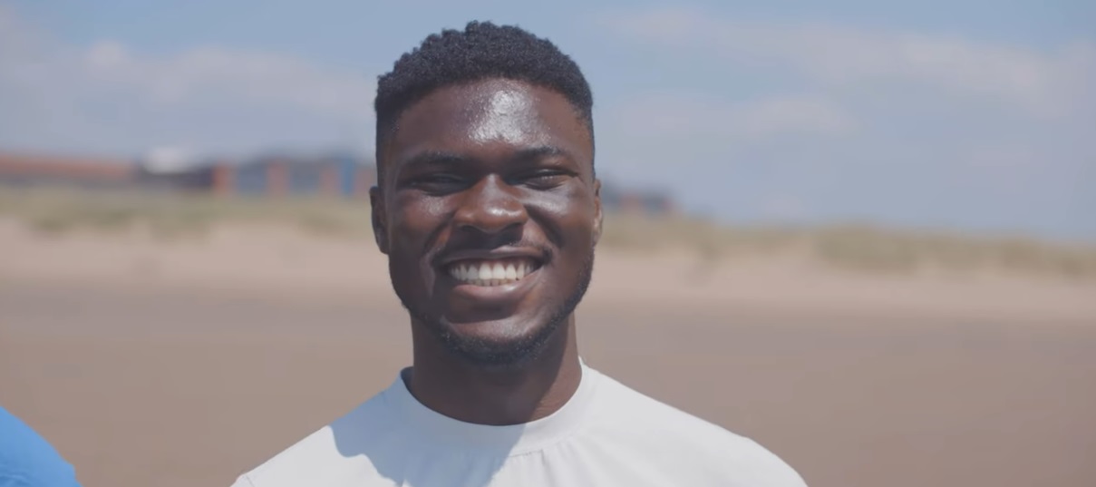 Man standing on a beach smiling
