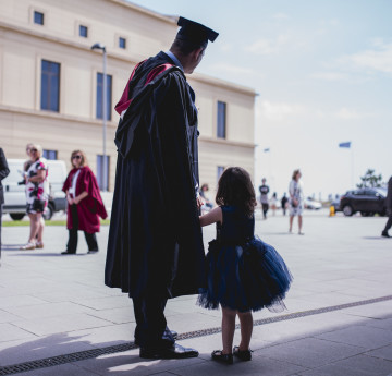 dad with little girl at graduation 