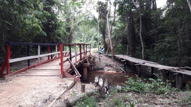 Image of the 'Feeder' Road project, with a newly made wooden bridge in the foreground. 