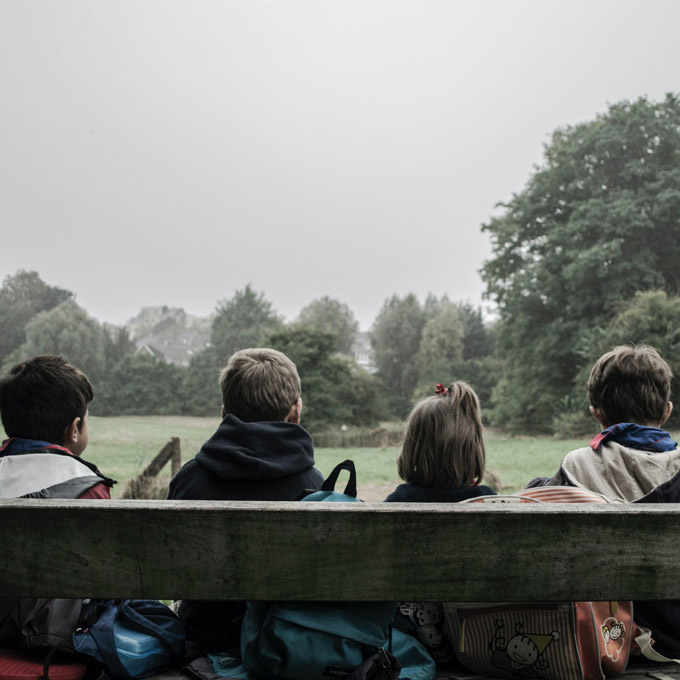 image of the children sitting on the bench