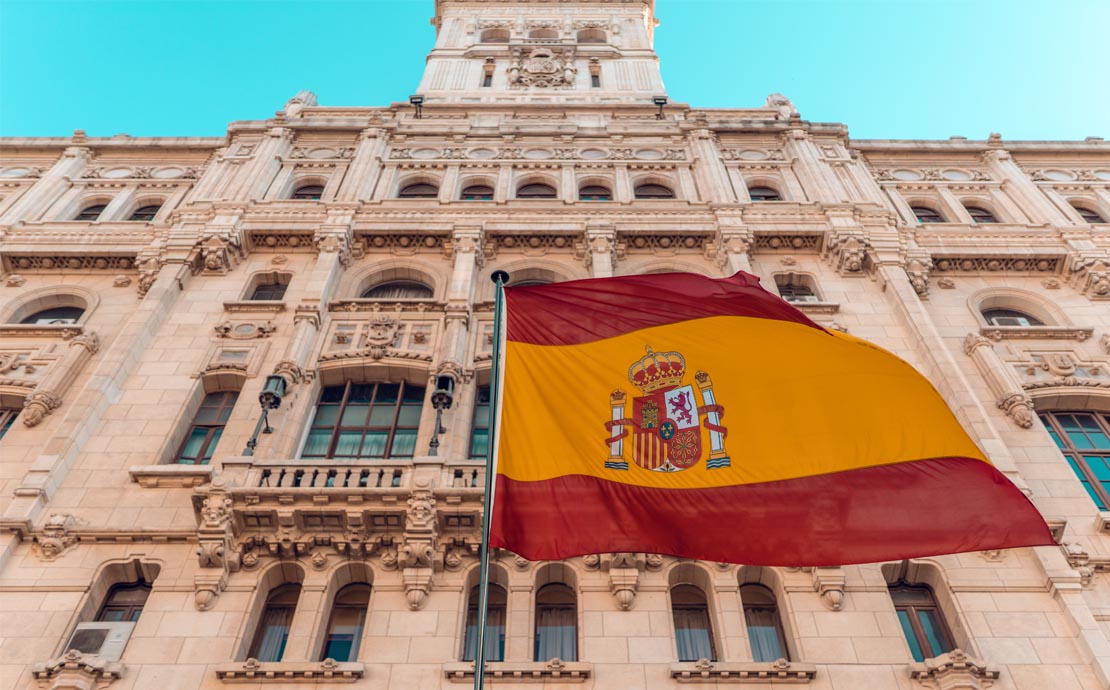 An image of a building in Spain with a Spanish Flag