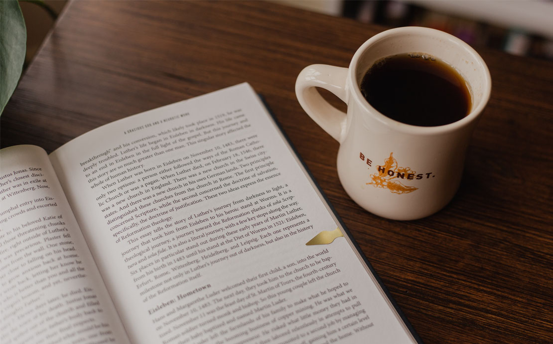 Image of a book and a mug with coffee