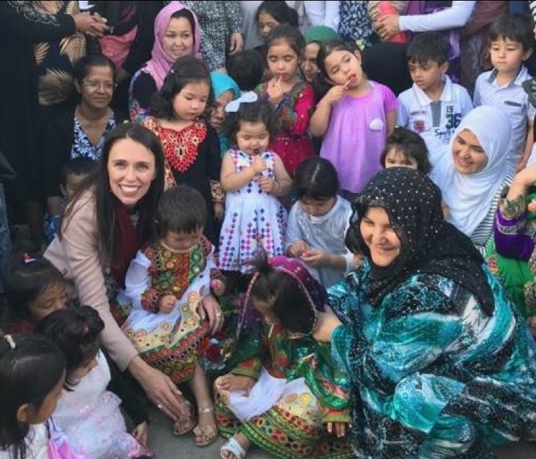 New Zealand Prime Minister surrounded by children. 