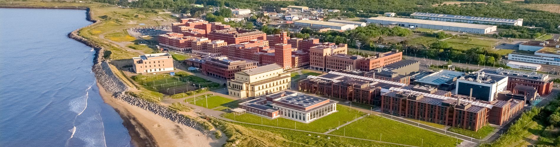 Aerial view of the bay campus, showcasing the buildings and proximity to the sea
