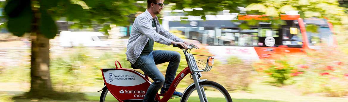 Man on a Swansea University Santander Cycles bike 