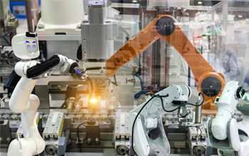 Robots working together in a factory production line