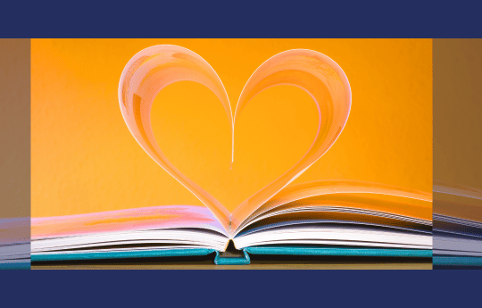 An open book with pages shaped into love heart.
