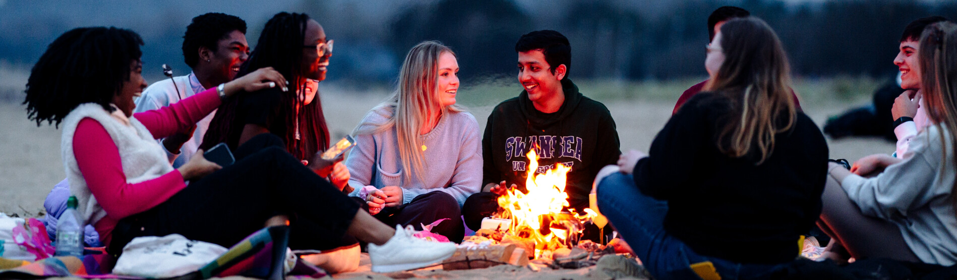 Students at a fire on beach