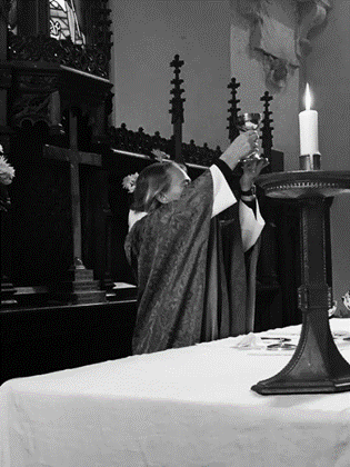 Rev. Gaynor lighting a candle