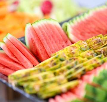 Slices of watermelon lined up on a tray