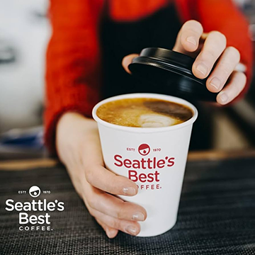 A server holding a coffee cup with seattle's best written on it