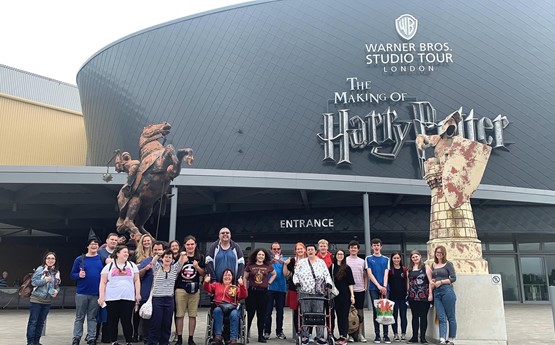 A group of Discovery volunteers and community members outside the Harry Potter studios in London.