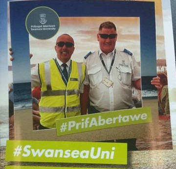 Geraint and a colleague pose with a giant Swansea University photo frame.